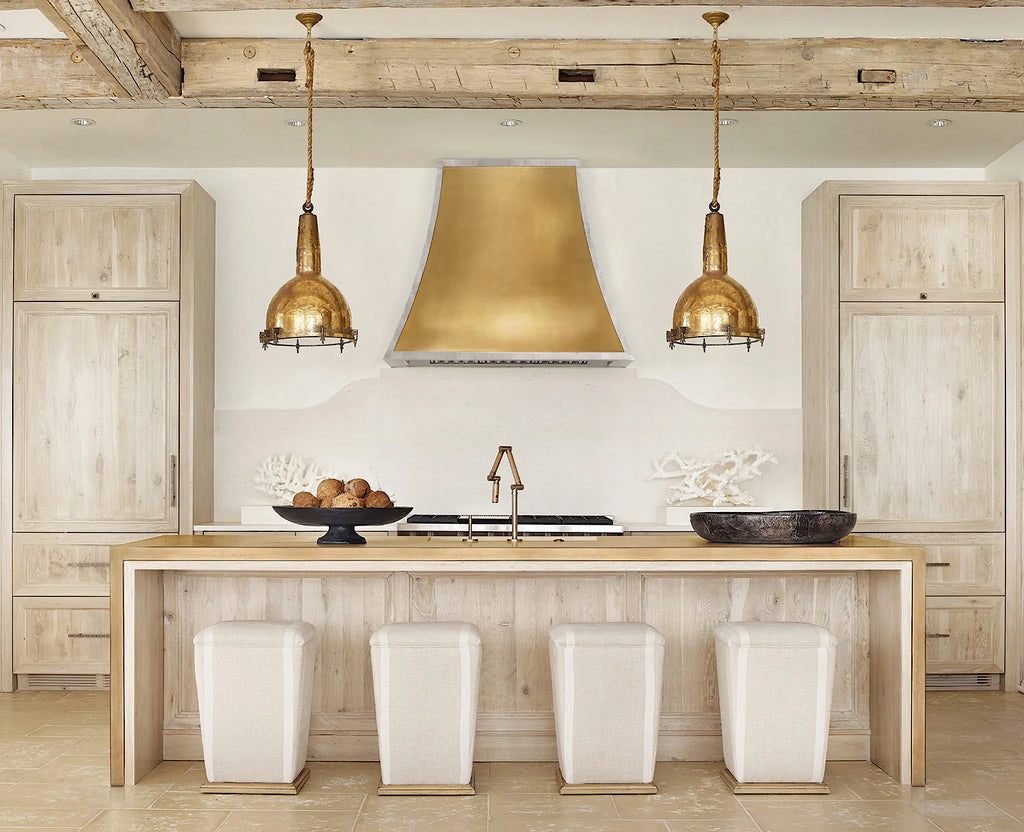Beautiful kitchen with centre island wrapped in gold metal detailing.