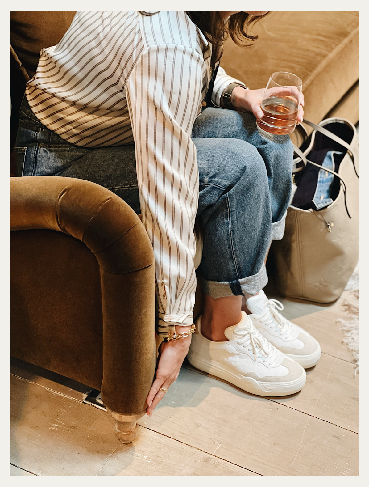 Katie Stephenson sit testing a sofa at High Point Market and feeling the curve of the sofa arm.