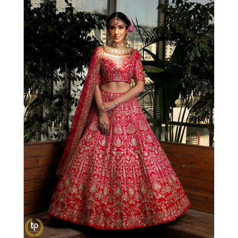 Cerise pink and crimson red silk bridal lehenga choli embroidered with abstract floral motifs in sequins, pearls, dori and zardozi; paired with a pink net dupatta embroidered in dori, pearls and zardozi for modern indian bride.