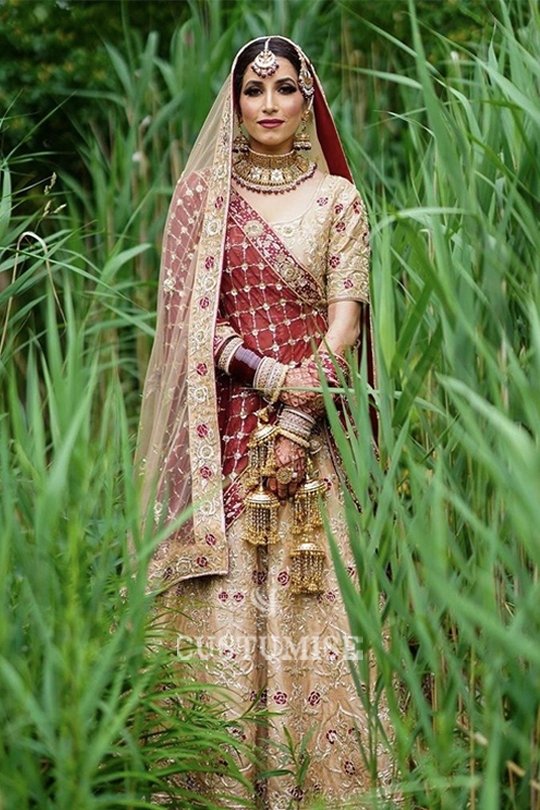 Our client Reena from UK wearing custom made indian bridal lehenga with custom hand embroidery. 