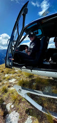 Man in helicopter on mountain top