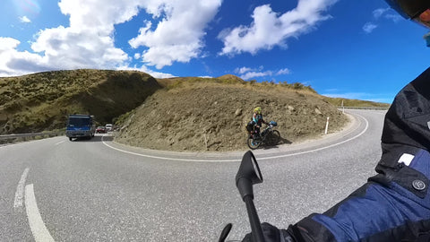 Motorcycle on bend with cyclist