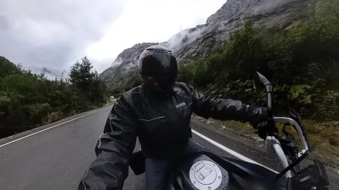 Milford sound mountains and a motorbike