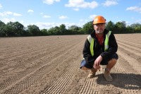 Barry Pace of Speedcut Contractors at Colchester United FC training ground with sand applied over rubber crumb on one of the main pitches   Copy