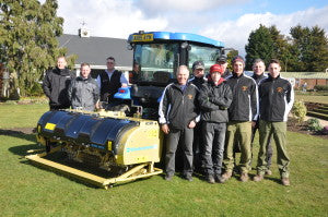 On the left of the gold painted Wiedenmann Terra Spike GXi8 are, from left, Eddie Jack and Stuart Paterson of Ernest Doe and Chas Ayres of Wiedenmann. On the right of the machine is Mick Lathrope, left, course manager at Eaton Golf Club and his greenkeeping team.