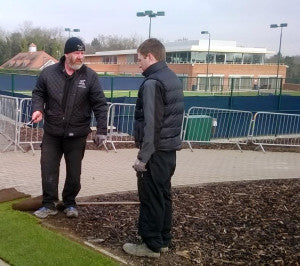 Figure 4 Apprentice, Tom Day, receiving a turfing lesson from Grounds Manager Dave Lawrence.