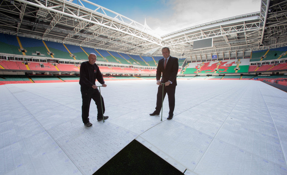 Stadium Manager Mark Williams (right) and Head Groundsman Lee Evans fix the final piece of the new state of the art Millennium Stadium jigsaw