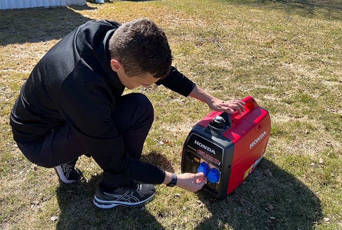 Man testing Honda EU22i generator