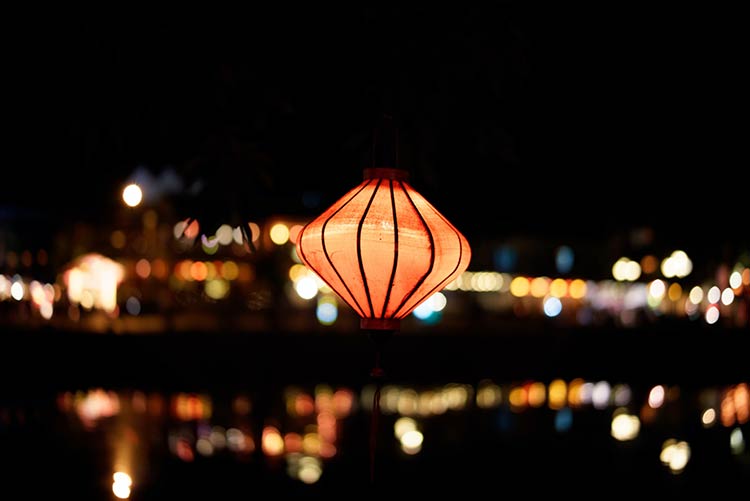 A red, Asian-inspired lantern appears to float in a cityscape