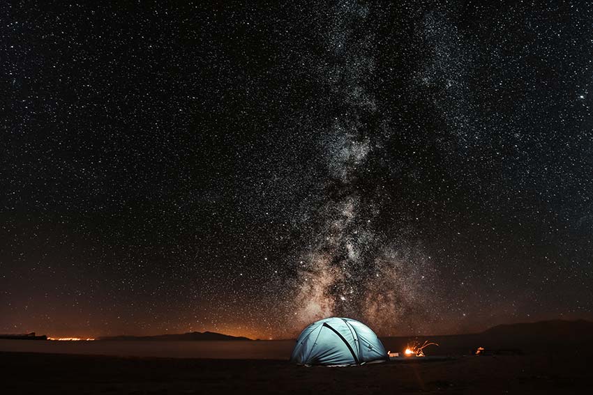 A lit-up tent under the stars. 