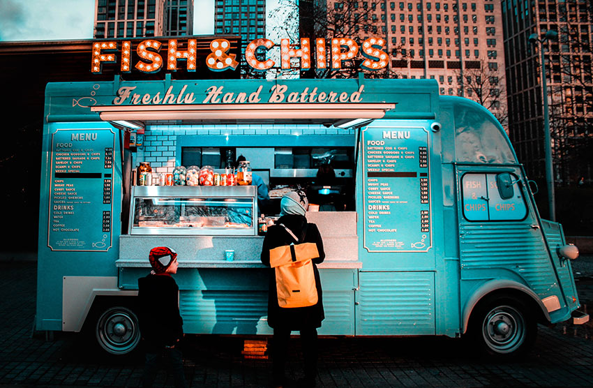 A bright blue food truck selling fish and chips