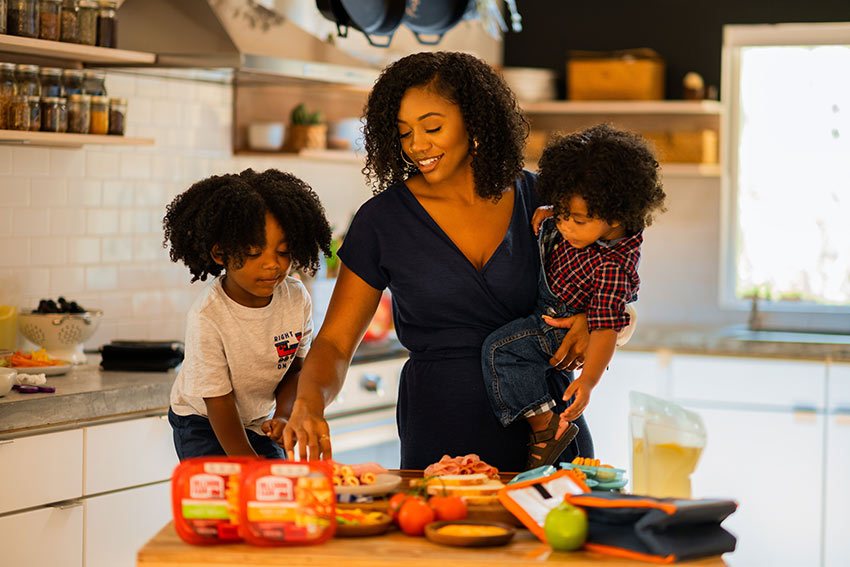 Mother and Son preparing food together in a well-lit kitchen