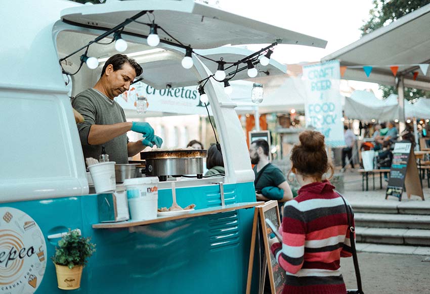 A food truck serving a waiting customer