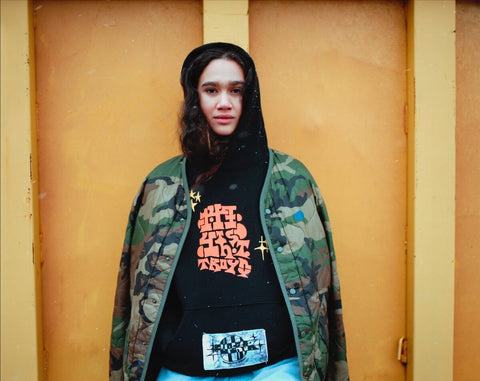 Model wearing collection hoodie.