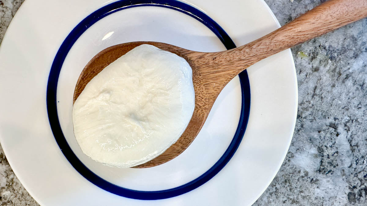 A spoonful of the luscious creamy interior that makes up burrata cheese.