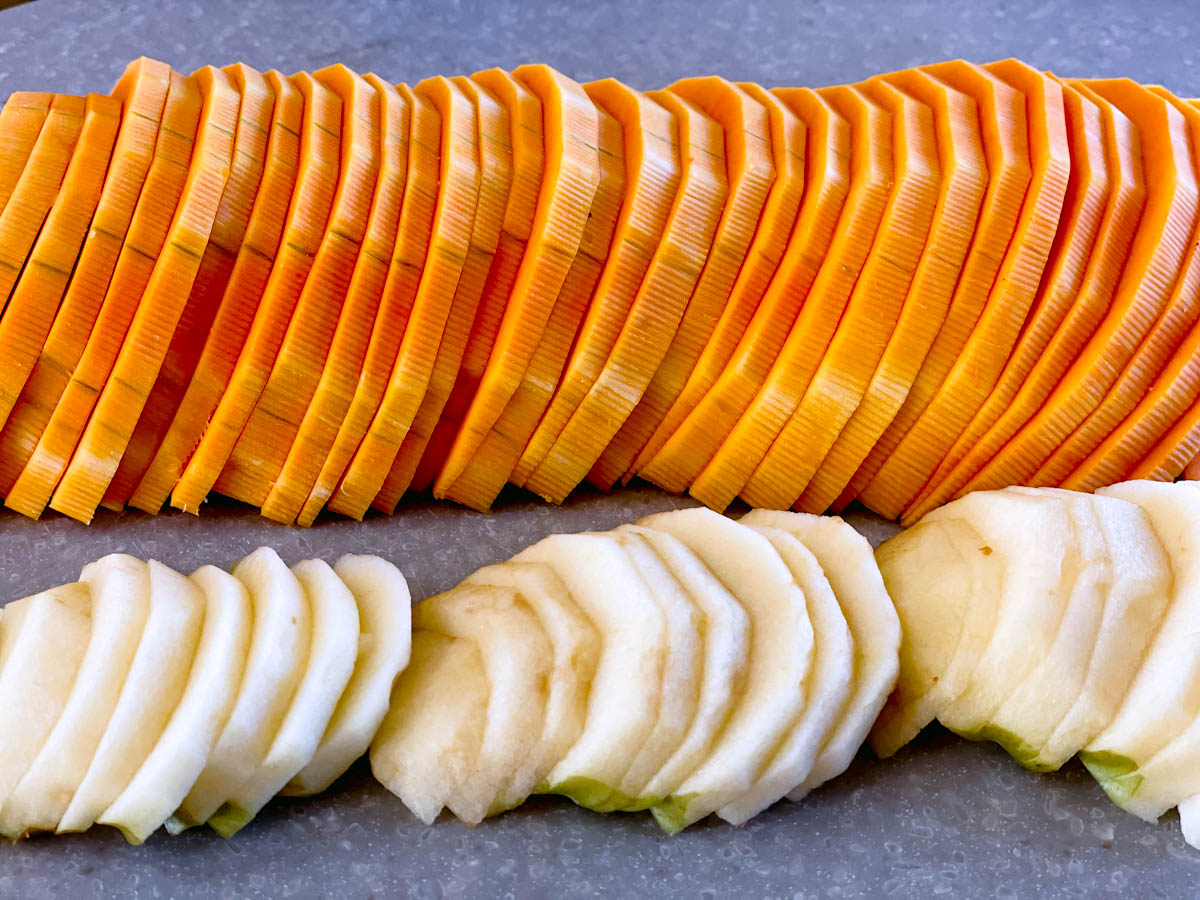 Sliced butternut squash and apple for a layered butternut squash crisp.