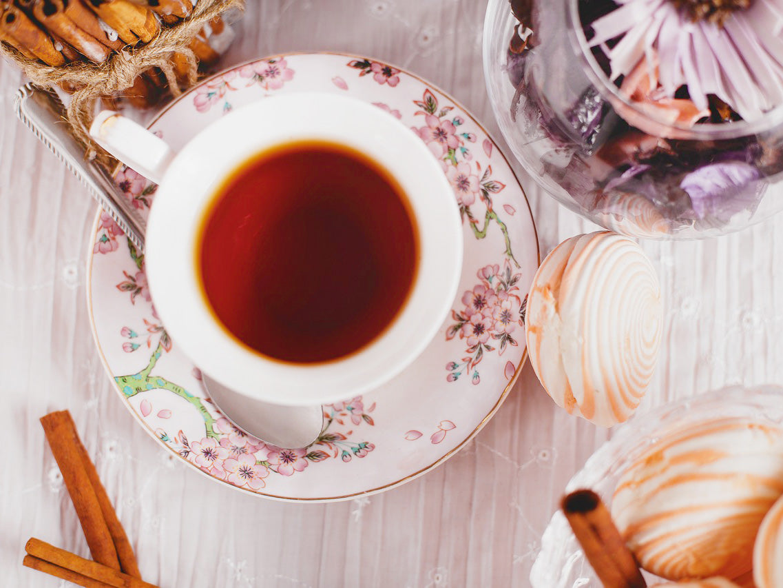 Overhead photo of a teacup and saucer full of tea.