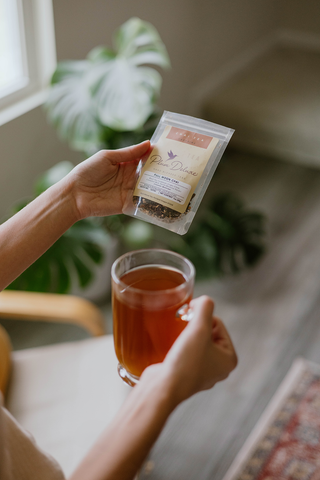 person holding a bag of loose leaf tea