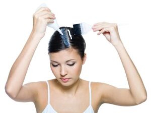 woman applying bleach to her hair