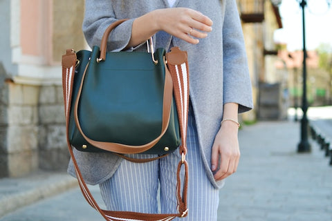 Woman holding a handbag where our scalp spray for psoriasis relief could easily fit