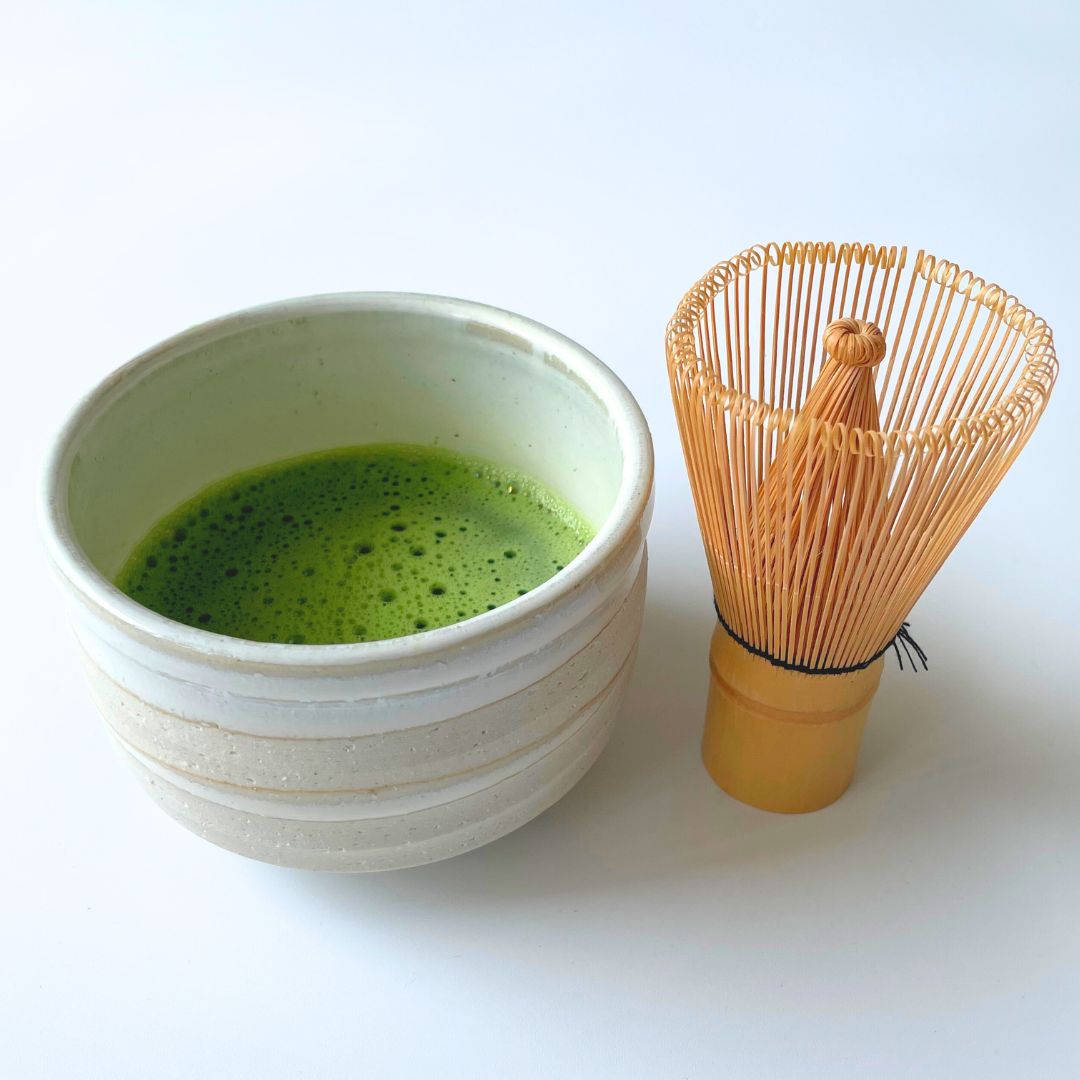 Bamboo chasen whisk and a bowl of matcha tea
