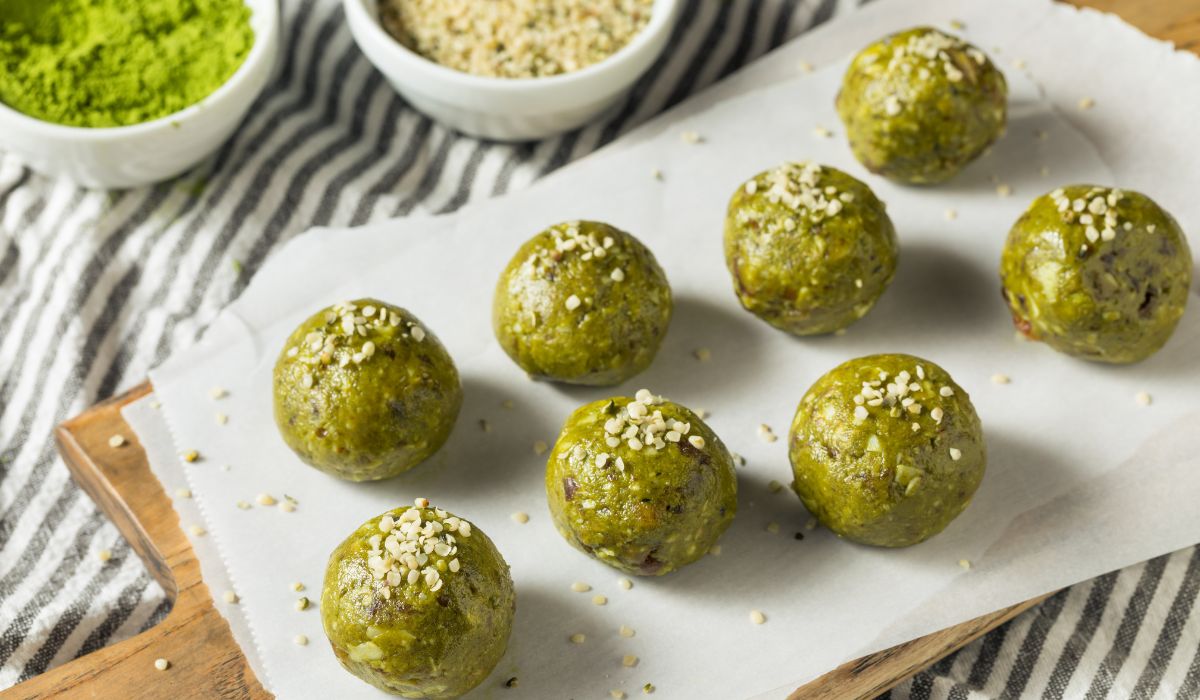Matcha energy bites or balls on a wooden board ready to eat