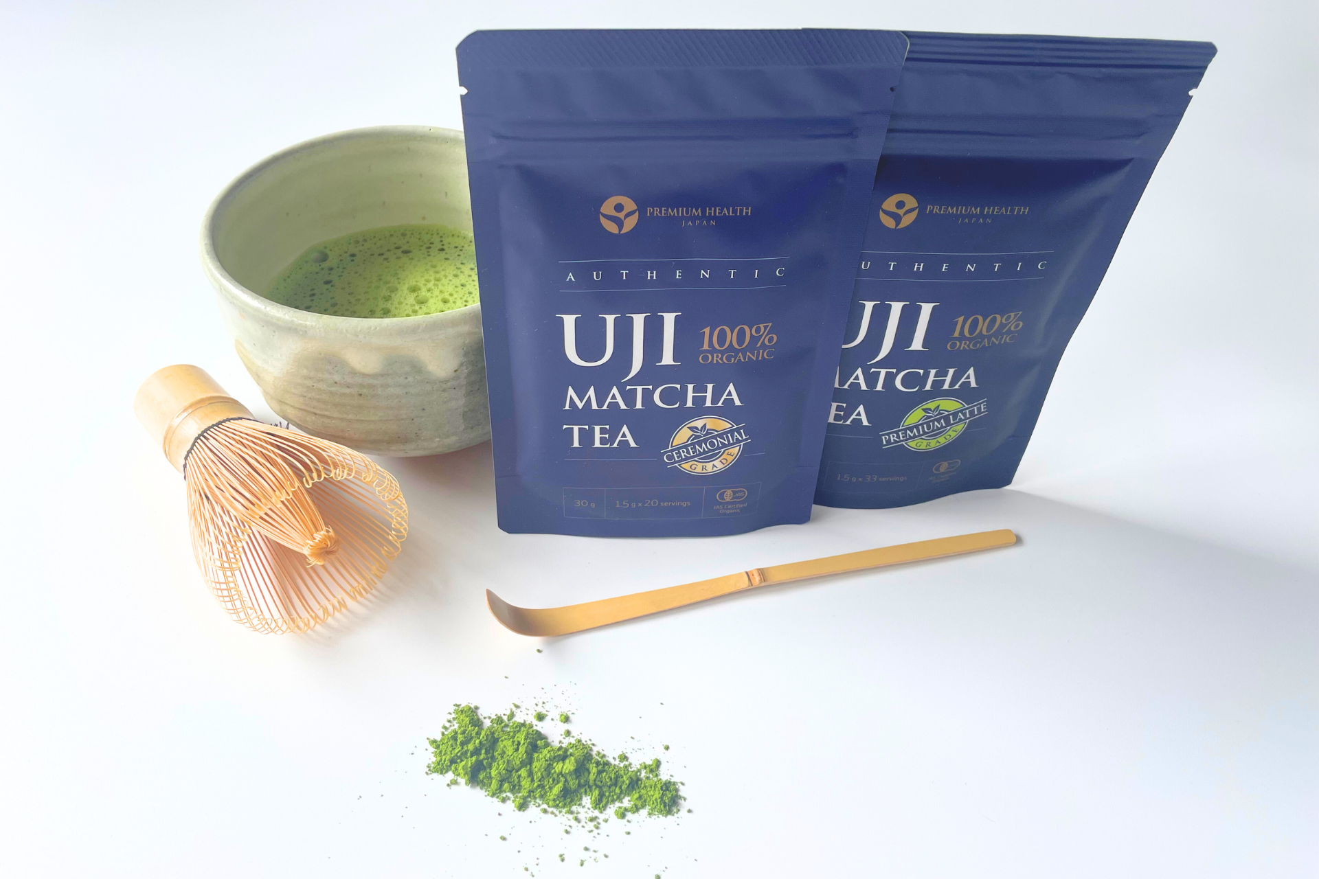 Product display with organic Uji matcha, matcha tea in a chawan bowl, bamboo matcha whisk and a chashaku scoop