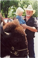 Man and girl next to buffalo