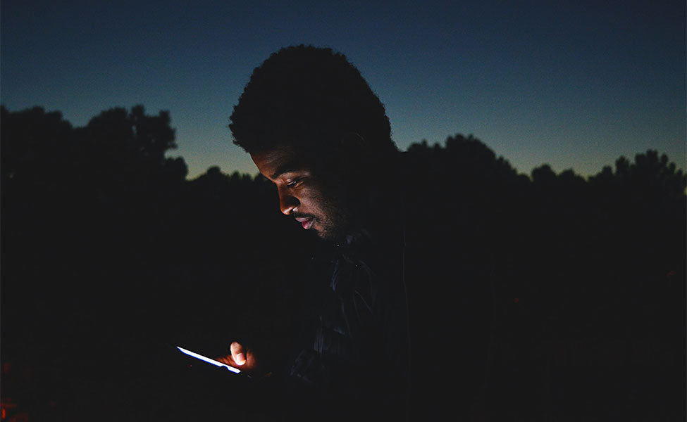 man using smartphone at night