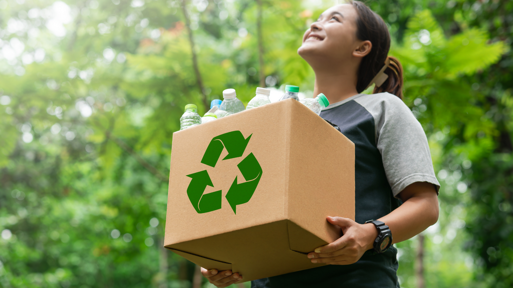 Woman recycling plastic bottles, aiding efforts on how to help endangered species.