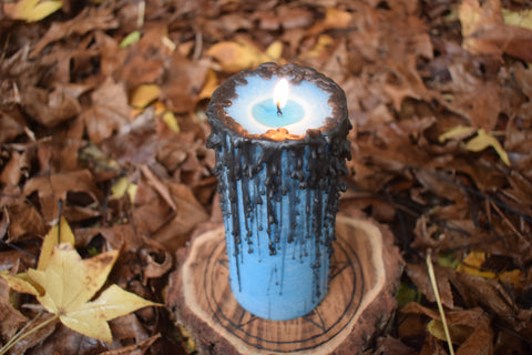 Large blue candle with black drips