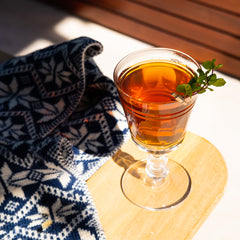 Winter Julep cocktail on table with scarf