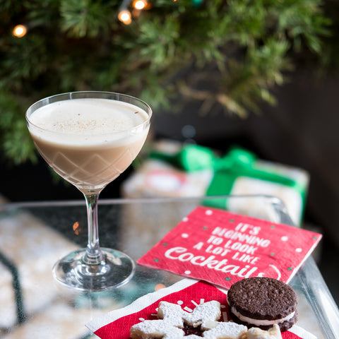 Fig Nog cocktail on indoor table in front of Christmas tree