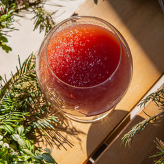 Liber Wassail cocktail on table with wreath