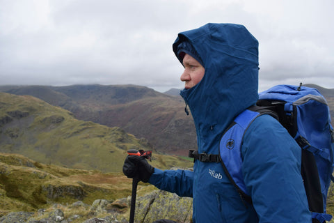 man in mountain with outerlayer or shell