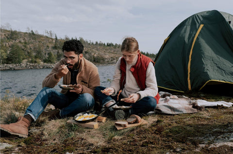 couple eating eggs at campsite backpacking wildcamping