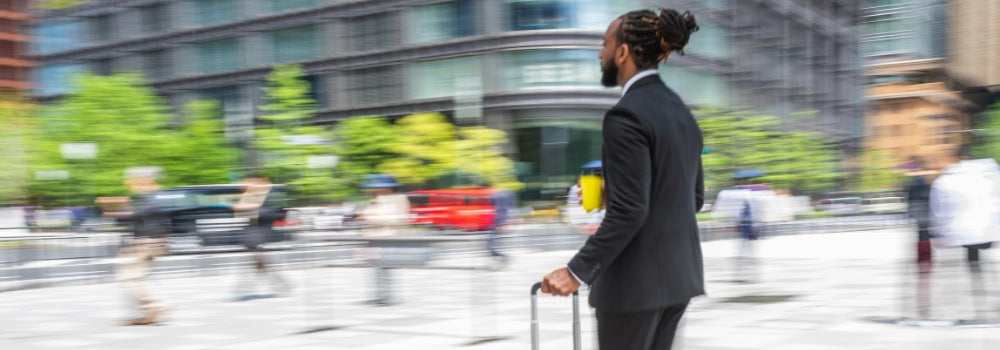 a black travel man is on the street