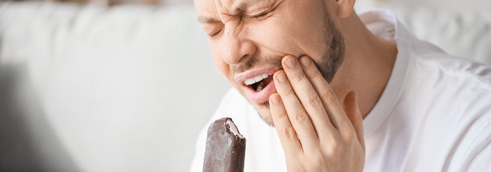 a man with his sensetive gum while eating ice cream