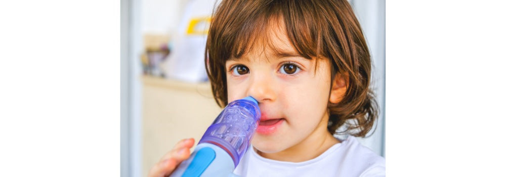 a white boy is using a nasal irrigation