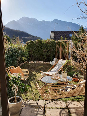 Outdoor seating area in Italy with mountain view, rattan and natural furniture theme