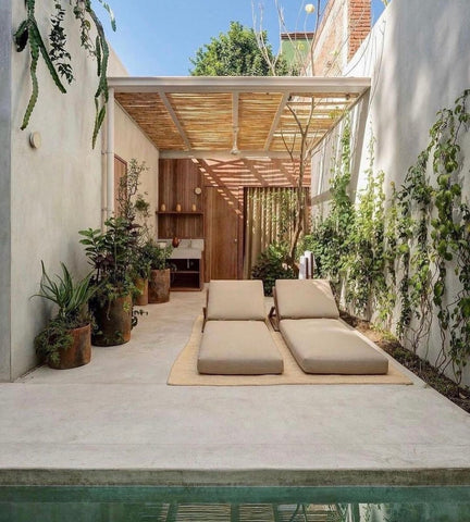 Laid back poolside utilising natural materials and neutral colour scheme