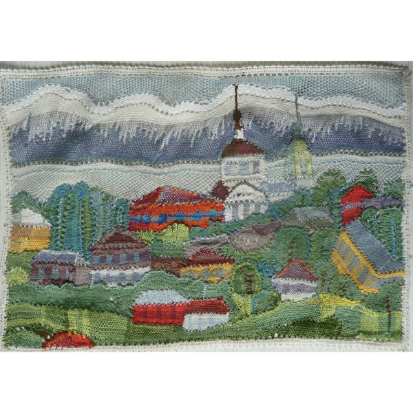 Beautiful russian village in green mountain landscape created in bobbin lace by artist Irina Ursinova