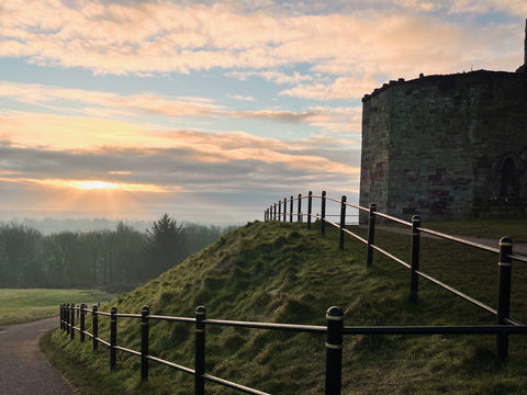 Picture of sunset in front of a castle 