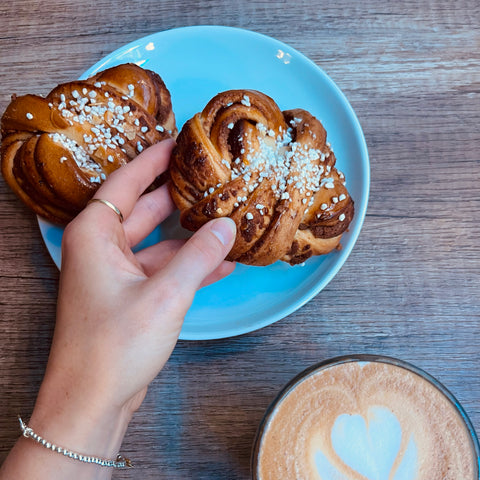 hand holding a cinnamon bun