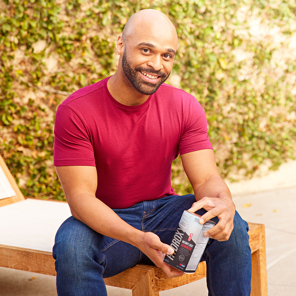 Andre holding a box of Hydroxycut Advanced