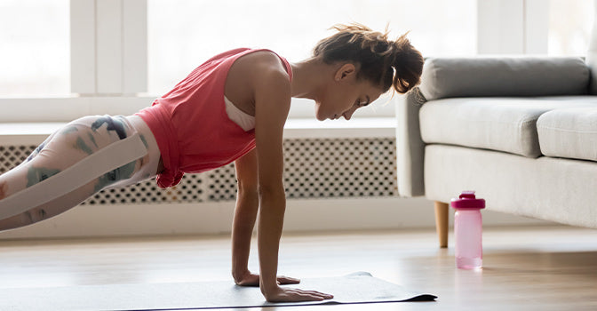 woman doing a plank exercise at home