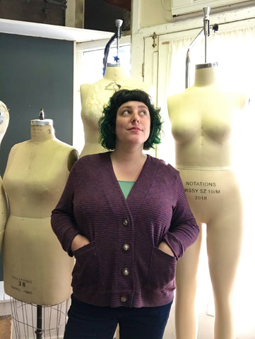 Ruby stands in front of several plus-size dress forms.