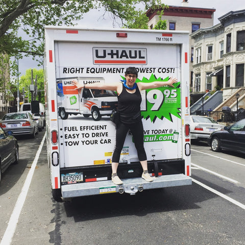 Me at 27 standing in the back of the UHaul before the big move.