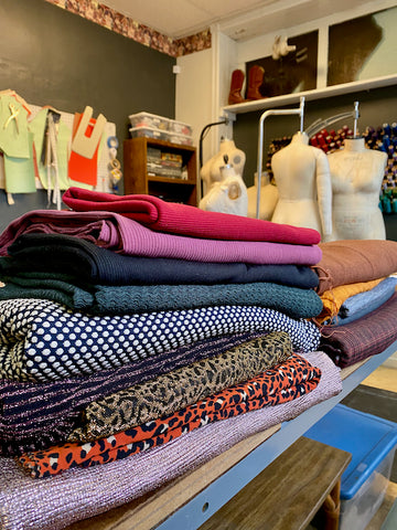 Piles of fabric were stacked all over my cutting tables.