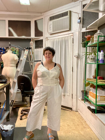 Ruby stands in her studio wearing a muslin mock-up of her wedding clothes.